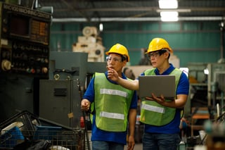Two industrial engineers observing a machine