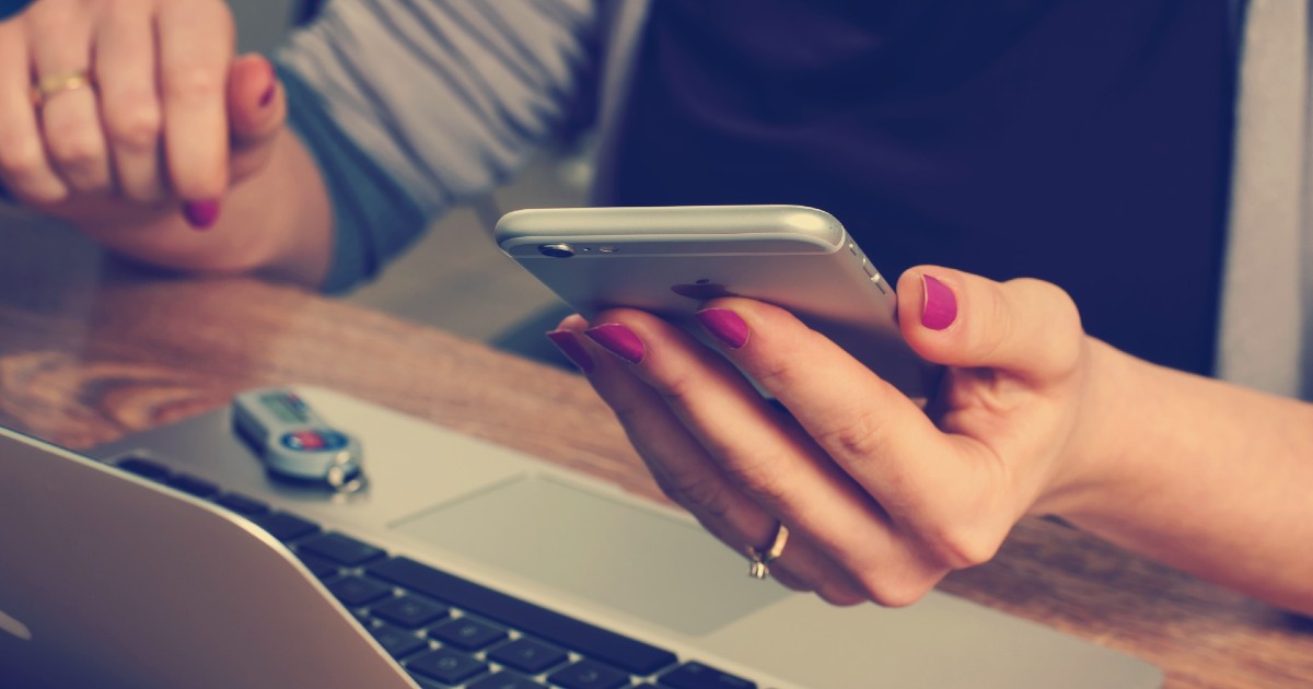 woman-using-phone-and-laptop