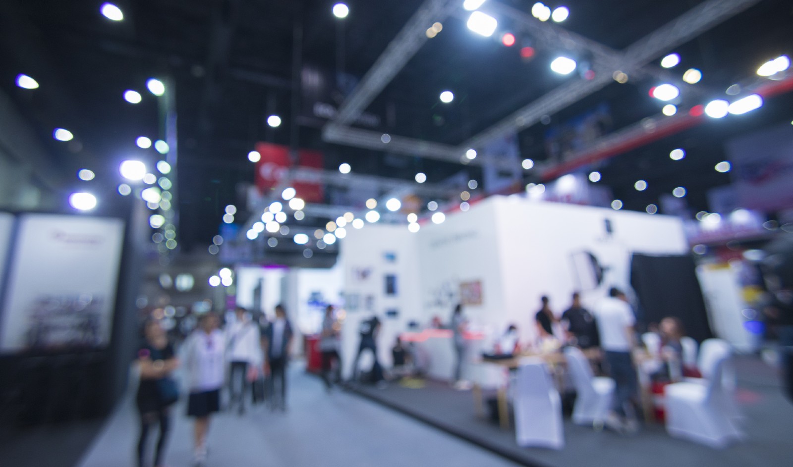 people walk around a trade show floor