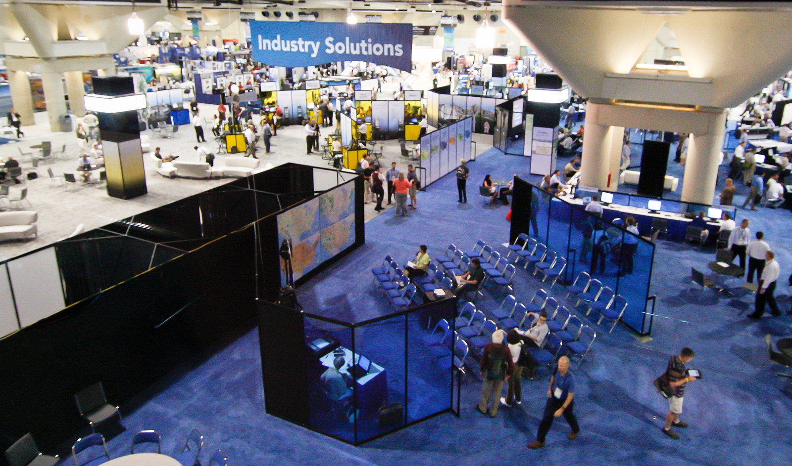 professionals walk around a trade show floor