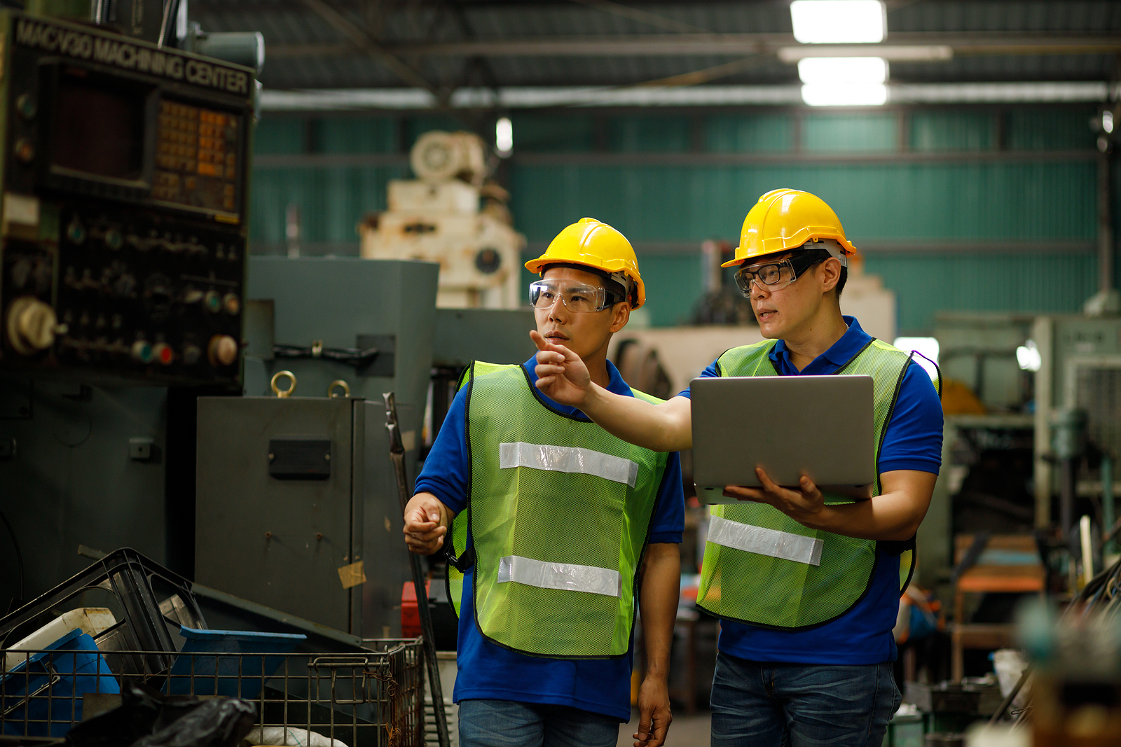 Two industrial engineers observing a machine