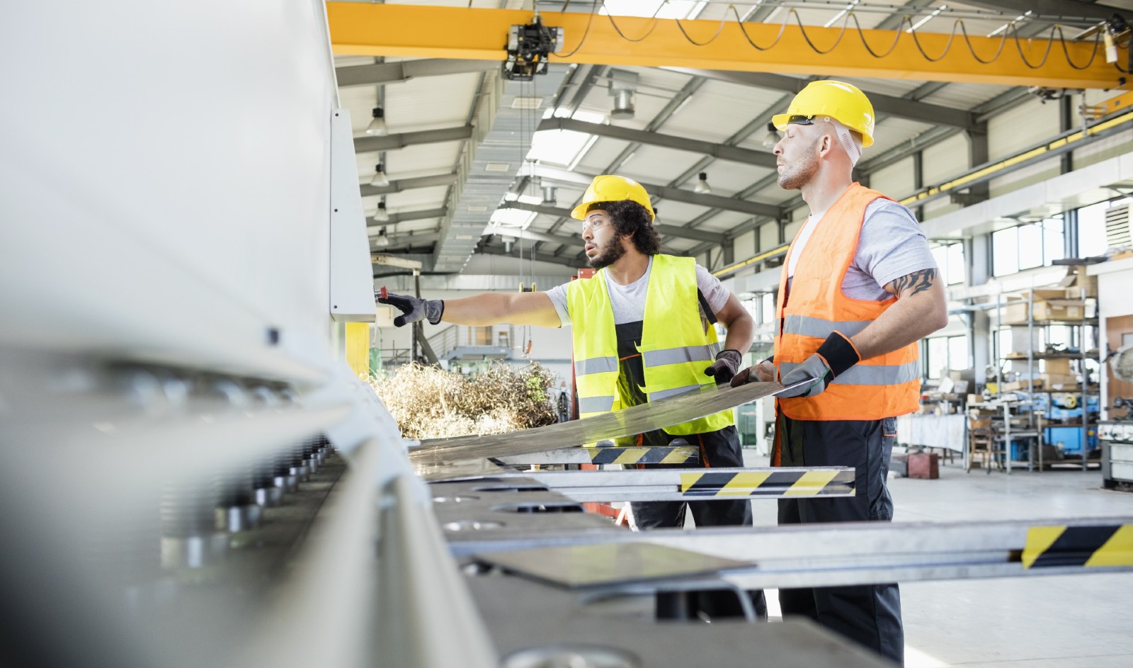 Workers creating unique product in manufacturing facility